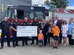 The Nine Fore Norm committee recently donated $5,000 to County of Brant Fire Service training in honour of the late Norman Booth. Pictured from left are Megan Wright, Robert Mercer, Graham Sayles, Wade Cummerson, Steve Jeles, Mayor David Bailey, Jay McLellan, Ray Werbicky, MPP Will Bouma, Darren Watson, Josie Mannen, Rick Mannen, Michael Bradley and Kim Carpenter. In the front row are Oliver Clarke, Erna Booth, Kayden Kellar.   Krystal Mercer and Susie Garn absent from photo.