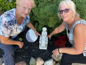 Mabel Dougherty, a former Brant County warden and reeve of Onondaga Township, and her daughter, Candy Watson, with a replica of a memorial statue of a boy on a tractor. The statue was stolen from the grave of Graeme Dougherty in Pleasant Hill Cemetery in Onondaga on July 12. Graeme was Dougherty's husband. SUBMITTED