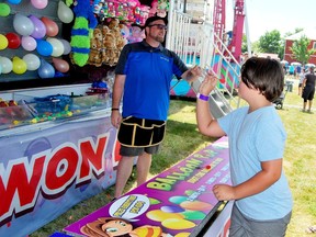 Danny O'Grady tries his hand at a balloon dart game at the Lansdowne Fair on Saturday. (KEITH DEMPSEY/Local Journalism Initiative)