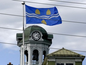 The city flag flies over the Brockville Railway Tunnel while City Hall's clock tower is seen in the background. (FILE PHOTO)
