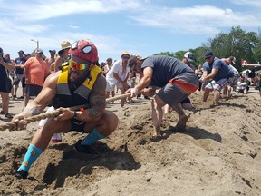 Brock Larade is shown at front with the rest of the 'Mother Tuggers,' as they won their pull competition over the Wheatley harbour during Fish Fest on Saturday. Trevor Terfloth/Postmedia