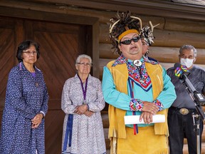 Flanked by clan mothers and Haudenosaunee Confederacy Council Chiefs, Cayuga Nation Chief Roger Silversmith speaks to reporters on Wednesday outside the Onondaga longhouse on Six Nations of the Grand River Territory.