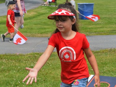 Alexis Boyle playing with the cornhole bean bags in the kids zone on Canada Day, pictured on Friday July 1, 2022 in Cornwall, Ont. Shawna O'Neill/Cornwall Standard-Freeholder/Postmedia Network