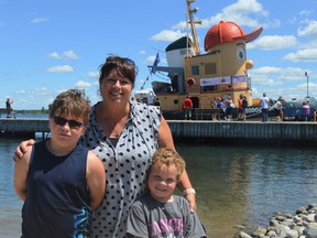 From left, Liam Kelly, Marilyn Racine, and Kullen Kelly enjoying themselves by the water, viewing Theodore Tugboat  on Sunday July 3, 2022 in South Dundas, Ont. Shawna O'Neill/Cornwall Standard-Freeholder/Postmedia Network