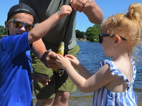 From left, Jack and Ruby Allaire excitedly looking at their first catch of the day at the 4th Fishing For Autism on Sunday July 3, 2022 in Alexandria, Ont. Shawna O'Neill/Cornwall Standard-Freeholder/Postmedia Network