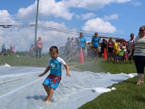 Weston, 4 was hesitant his first try of the slip'n'slide on Friday July 22, 2022 in St. Andrews West, Ont. Laura Dalton/Cornwall Standard-Freeholder/Postmedia Network