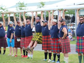 Athletes in the amateur division of the heavyweight events have some fun while posing with the caber at the Glengarry Highland Games. Photo on Friday, July 29, 2022, in Maxville, Ont. Todd Hambleton/Cornwall Standard-Freeholder/Postmedia Network