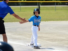 Handout/Cornwall Standard-Freeholder/Postmedia Network
Cornwall River Rats 8U player Elliot Lefebvre gets a five from coach Brian Dufresne at third base in a 2022 season game.