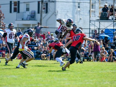 The Myers Riders ball carrier leaps over Cornwall Wildcats Logan Paulin during play on Saturday July 9, 2022 in Cornwall, Ont. The Wildcats lost 42-36. Robert Lefebvre/Special to the Cornwall Standard-Freeholder/Postmedia Network