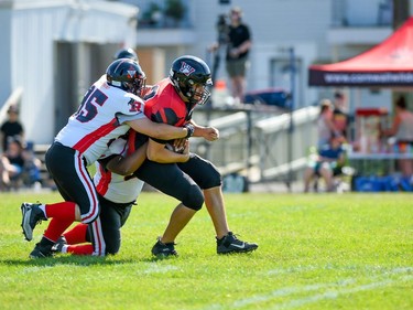 Cornwall Wildcats quarterback Xavier Uhr is tackled during the team's game against the Myers Riders on Saturday July 9, 2022 in Cornwall, Ont. The Wildcats lost 42-36. Robert Lefebvre/Special to the Cornwall Standard-Freeholder/Postmedia Network