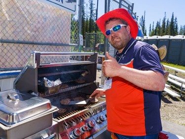 Brent Moore poses while working the grill during Bragg Creek Days festivities in Bragg Creek on Saturday, July 16, 2022.