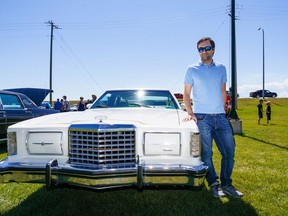 Mike Stein poses with his 1978 Ford Thunderbird at the 567 Corner Classic car show in Alberta on Saturday, July 23, 2022. The Thunderbird has a long history in Stein's family, they own eight in total.
