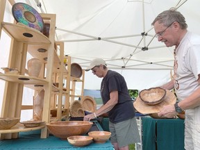Ken Waller displays his artisan bowls at ArtFest with the help of his wife Joyce on Thursday, June 30, 2022. Sophia Coppolino/For The Whig-Standard