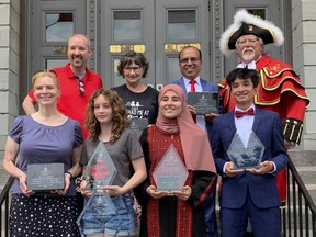 The 2022 Canada Day Civic Ceremony award recipients with Mayor Bryan Paterson (top left) and Town Crier Chris Whyman (top left) on the steps of City Hall in Kingston, Ont. on Friday, July 1, 2022. 
Back - Paterson, Donna Cowie-Ducharme, Jamshed (Jimmy) Hassan, Chris Whyman
Front - Dr. Elaine Ma, Julia Stevens, Yara Hussein and Andrew Chin
