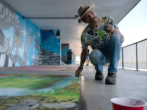 Roberto Vergara Lino puts the finishing touches on his tropical scene at the Chalk Walk, on Saturday evening during the 2022 Kingston Buskers Rendezvous in Kingston. Lino, a mural artist with works in Poland and Germany, was participating in the Established Artists category.