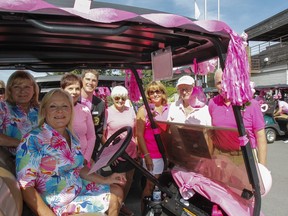 Sherri McCullough, front, chair of the annual Rose of Hope women's golf tournament, gathers volunteers and golfers for a photo before taking to the links at Cataraqui Golf and Country Club in support of breast cancer programs at Kingston Health Sciences Centre on Tuesday.