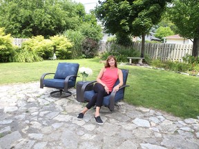 Melinda Vanzanten sits in the backyard of her west-end home, where she plans to build a small detached house as a rental income property.