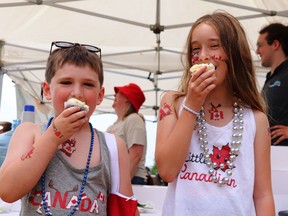 Nothing tastes as good as Canada Day cupcakes. Cousins Liam (6) and Brielle (11) thoroughly enjoyed themselves at the Mad Hatter's Tea Party as Canada Day officially began in Joel Stone Park in Gananoque on July 1.  Lorraine Payette/for Postmedia Network