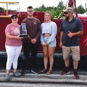 Foto door KEVIN McSHEFFREYNash en Reese Farquhar (midden), kinderen van wijlen Deric Farquhar naar wie dit evenement is vernoemd, overhandigden de trofee aan Blind River loco-burgemeester Paula Summers (uiterst links), winnaar van de Mayor's Challenge van dit jaar met Elliot Lake Mayor Dan Marchisella, die verloor.