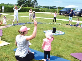 Photo by KEVIN McSHEFFREY
Michelle Deschenes, of The Oaks Yoga, got the children at the Teddy Bear Picnic on Thursday, July 7, and some of the parents, to do yoga exercises.