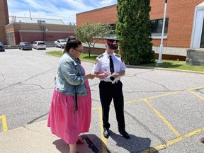 Kelsie Etches, chair of OutLoud talks with North Bay police Insp. Jeff Warner in July about the online hate comments and death threats. GREG ESTABROOKS