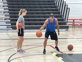 Professional hoopster Joey Puddister trains with a young player at Canadore College.