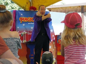Steve Harmer, magician with Magic Plus Entertainment, engaged the crowd during one of his magic shows for the Kootenai Brown Pioneer Village Shindig event.