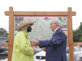 Ontario Lt.-Gov. Elizabeth Dowdeswell chats with Petawawa Mayor Bob Sweet in front of a map of the Algonquin Trail during the opening of town's 25th anniversary celebration on June 30. Anthony Dixon