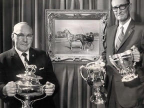 Sydney Warris, left, holds a silver racing cup won by the famous racehorse, The Eel, while T.W. Orr, president of the Perth County Historical Foundation, holds two more cups won by The Eel in 1909. 

Stratford-Perth Archives