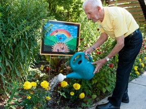 Stratford gardener and honorary Communities in Bloom member Bernie van Herk waters plants at the Ted Blowes Memorial Garden on Friday.  Stratford's Communities in Bloom committee is accepting nominations for this year's Best Blooming Gardens contest.  (Chris Montanini/Stratford Beacon Herald)