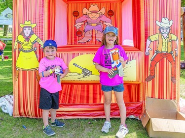 BANG ON Connor O'Dell, 4 and Rose O'Dell, 7 prepare to take aim at the RotaryFest inflatable shootout station. The Northern Dental Care Inflatable Park featured other inflatable play stations and activities for children at Clergue Park during RotaryFest. BOB DAVIES