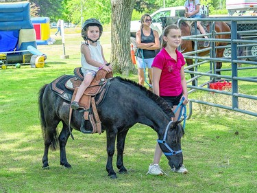 PONYFEST Holly Wissell, 4, enjoys a pony at Friday's RotaryFest. Hidden Hills Stables offered the pony rides during the three-day festival at Clergue Park. BOB DAVIES
