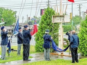 END OF AN ERA Members of the Royal Canadian Branch 25 Legion lower the flags at the Great Northern building last Wednesday for the last time.  The 55-year-old building will soon be demolished to make way for a new Branch 25 location and apartment complex. BOB DAVIES
