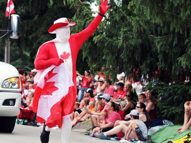A person in a skin-tight Canadian flag-themed suit waves at the crowd during Sarnia's Canada Day parade on Friday. Terry Bridge/Sarnia Observer/Postmedia Network