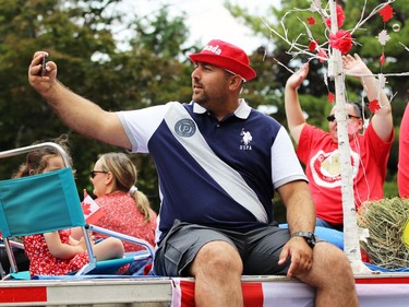 A man takes a selfie while riding on a float in Sarnia's Canada Day parade on Friday. Terry Bridge/Sarnia Observer/Postmedia Network