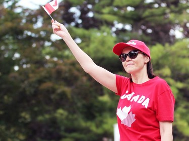 A woman waves a small Canadian flag during Sarnia's Canada Day parade on Friday. Terry Bridge/Sarnia Observer/Postmedia Network