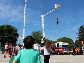 Colin McDougall from Wyoming Tree Service dangles from a wire during Plympton-Wyoming's Canada Day party on Saturday.  Terry Bridge/Sarnia Observer/Postmedia Network