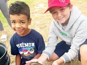 Winston, left, and event volunteer Brayden (last names not available) are pictured at the kids fishing derby on Friday morning.  The event kicked off Petrolia's full day of Canada Day celebrations.  (Facebook)