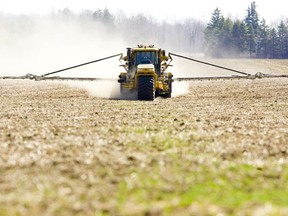 Randy Wilcox of Strathroy fertilizes a field just north of Komoka.  File photo / The London Free Press