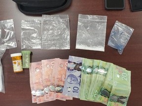 Drugs and cash seized during an arrest on Saturday, July 9, 2022, are shown in this photo provided by Sarnia police. (Sarnia police)