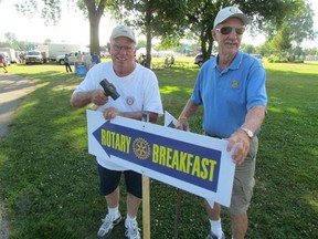 Rotary Club of Sarnia volunteers are shown in this file photo setting up signs to the club's annual Mackinac Race pancake breakfast, which is set to return Saturday morning at Point Edward's Waterfront Park.