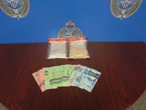 Cash and drugs allegedly seized Wednesday during an arrest are shown in this photo provided by Sarnia police.