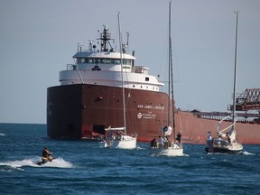 The ship, Hon James L. Oberstar, heads to the St. Clair River as sailboats head into Lake Huron near Sarnia Saturday.