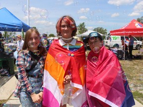 From left, Baya Vandenheuvel, Bee Wamsley and Tristan Daamen stand in a sea of ​​bubbles Saturday at Sarnia-Lambton Pridefest in Sarnia's Centennial Park.