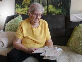 Sarnia's Jean Simpson holds some of the letters she has received about her 30-year battle with Ontario's worker compensation system over her late husband's claim that working at the former Fiberglas plant in Sarnia contributed to the cancer he died of in 1997.