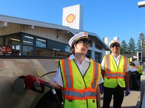 Christine Hodge, left, and Krishna Moorthy of Shell Canada help at a free gasoline event Thursday morning at Don Holden's Shell in Sarnia that was part of the company's celebration of the 70th anniversary of its refinery in Corunna.
