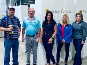 From left, Bob Schenck and Gary Cannon, with the Carpenters Union Local 1256, Nicole Paquette and Michele Stokely, of Noelle's Gift, and Amy Cunningham of Dow stand next to one of the closets holding clothing and personal care items that will be distributed to schools in Lambton County and Chatham-Kent.