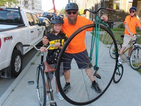 Jordan Brown and his son, Konahn, 10, with their Penny Farthing cycles before the start of Friday's BIG Slow Roll in Sarnia.