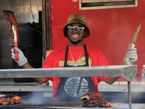 Kabange Awanakitenge slices up a rack of ribs during the frst ever Rotary Ribfest in Spruce Grove. Photo by Josh Thomas, Rep/Ex Staff.
