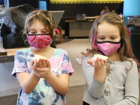 Ayriana McCoshen, 7, left, and Ava Dunphy, 7, visit the Nature Exchange at Science North on March 15.